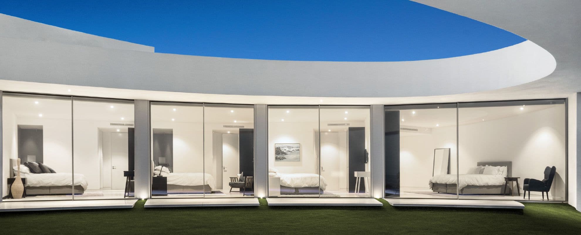 Wide aluminium glazed doors connecting a living space to the garden